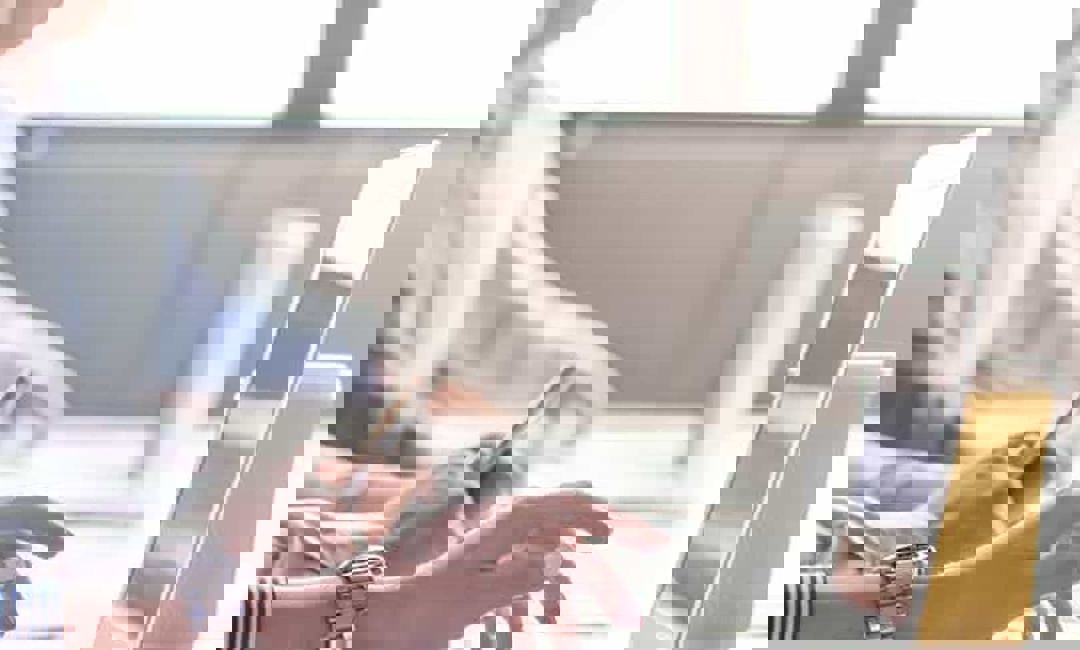 A man looking at his phone and looking puzzled