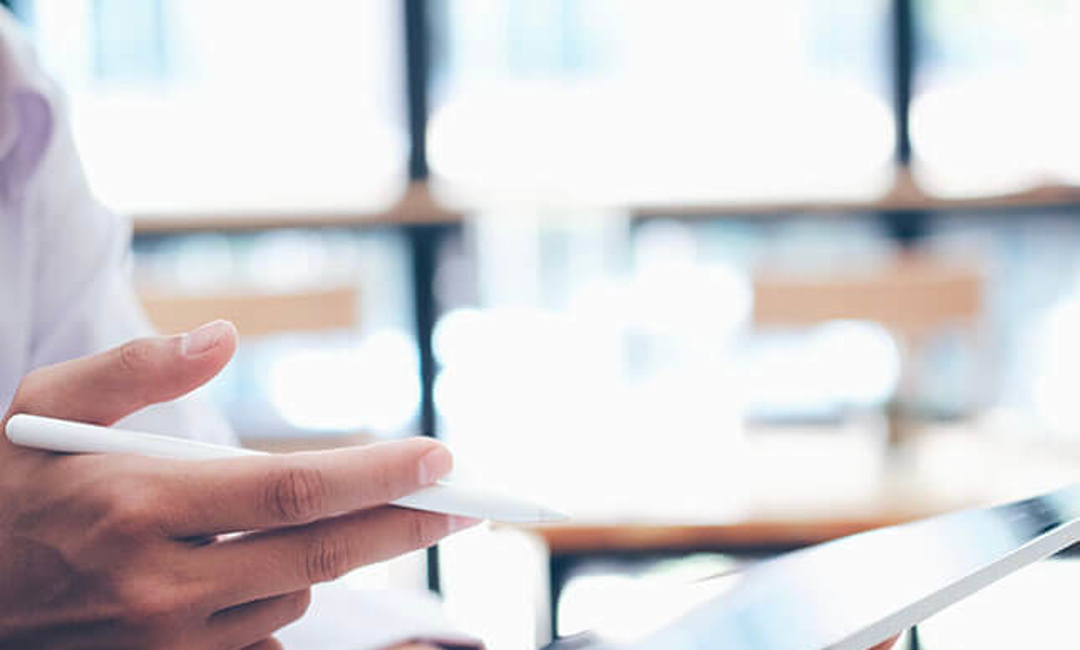 hand holding an iPad