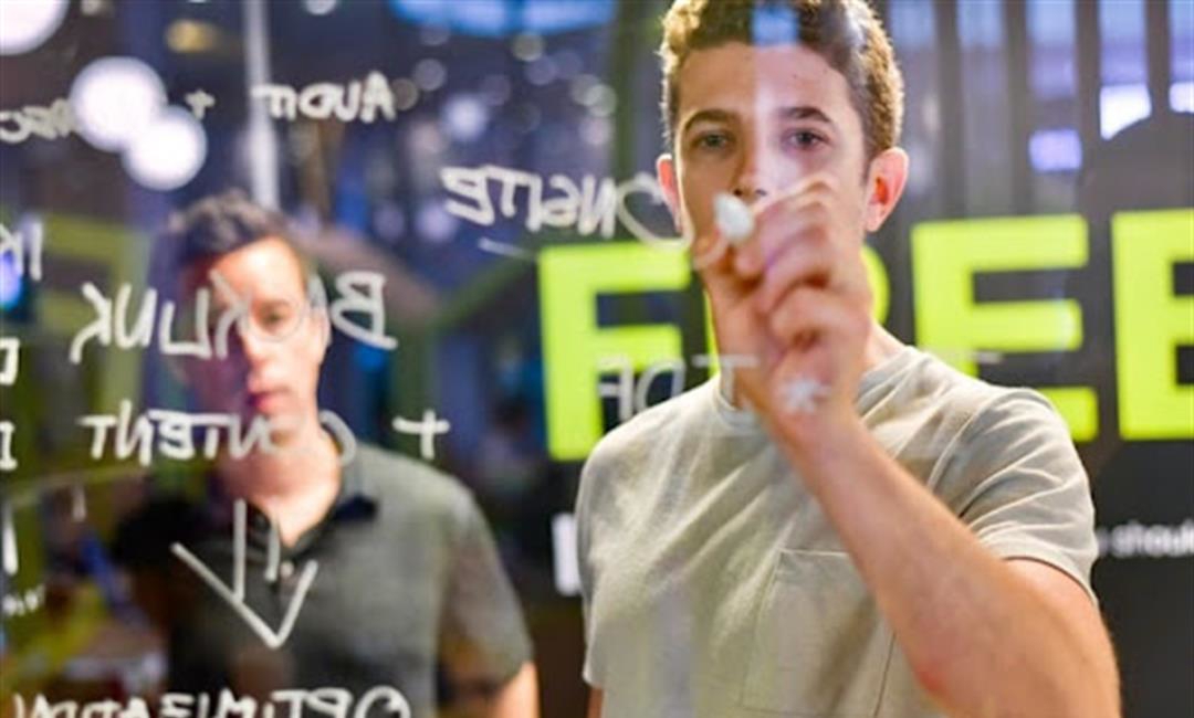 Two people writing up ideas to advertise their business