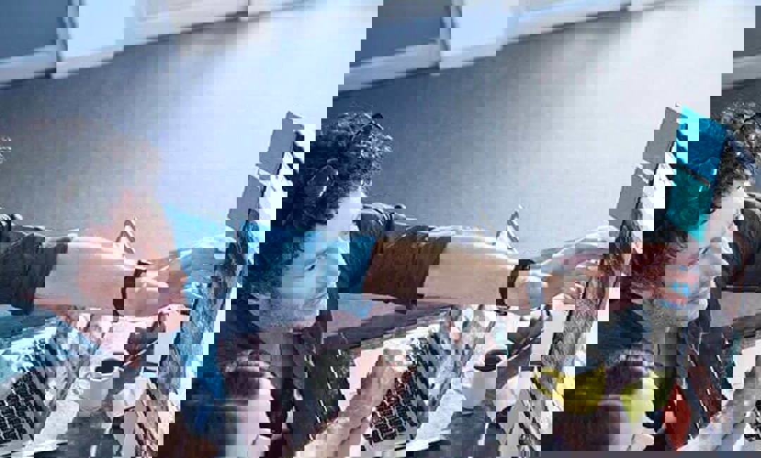 image of two people collaborating in front of computer