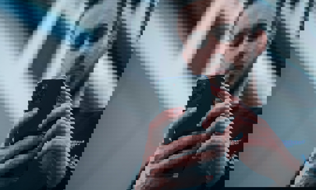 Man looking at reviews on iPhone