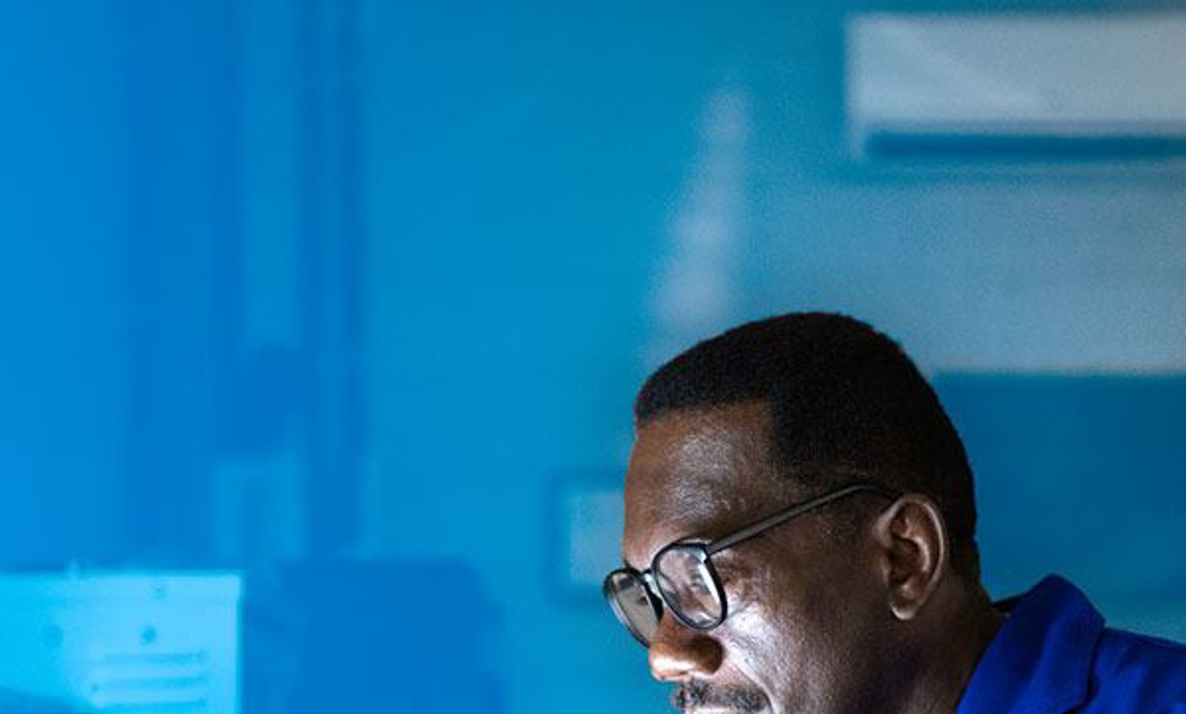 Man on a computer in an industrial workshop