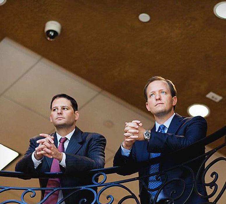 lawyers arnold and itkin resting on a banister