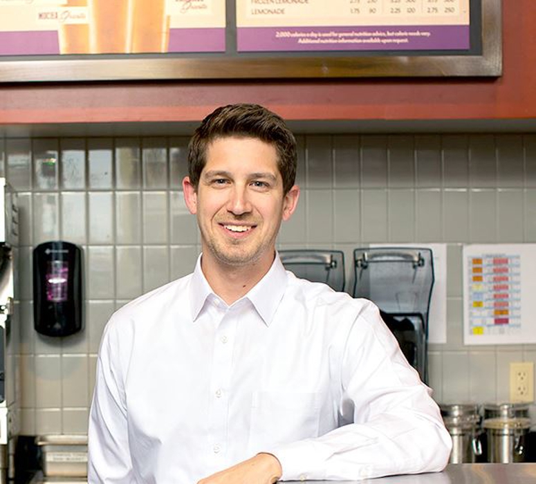 franchisor leaning on counter