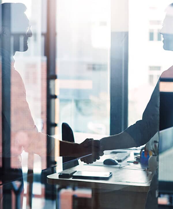 2 people shaking hands.