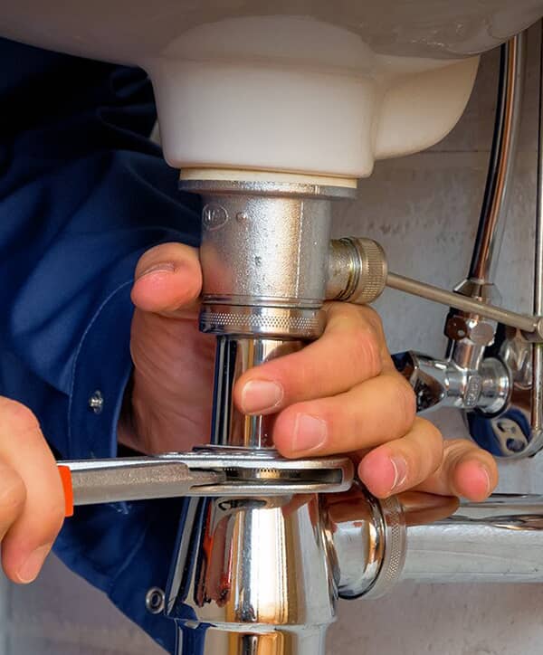 Plumber fixing pipes
