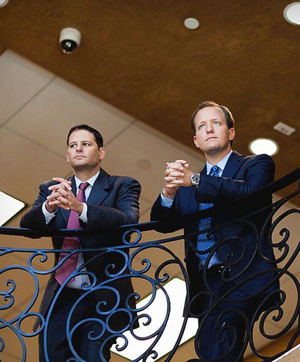 lawyers arnold and itkin resting on a banister