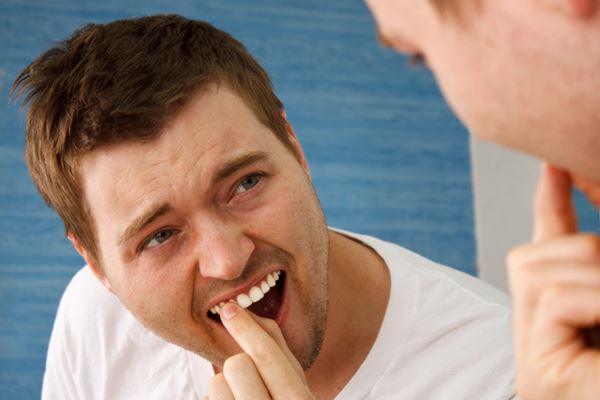 A man checking on his teeth.