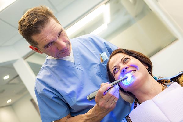 A dentist working on a patient.